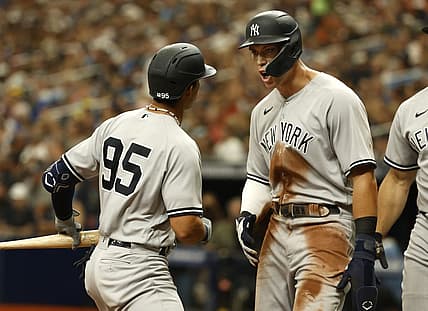 Sep 4, 2022; St. Petersburg, Florida, USA; New York Yankees right fielder Aaron Judge (99) celebrates as he scores a run on shortstop Oswaldo Cabrera (95) sacrifice RBI against the Tampa Bay Rays during the seventh inning  at Tropicana Field. Mandatory Credit: Kim Klement-USA TODAY Sports