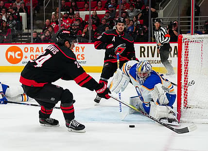 Dec 2, 2023; Raleigh, North Carolina, USA; Carolina Hurricanes center Sebastian Aho (20) sends the past to  center Seth Jarvis (24) past Buffalo Sabres goaltender Eric Comrie (31) during the first period at PNC Arena. Mandatory Credit: James Guillory-USA TODAY Sports