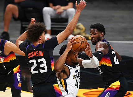 Apr 7, 2021; Phoenix, Arizona, USA; Utah Jazz guard Donovan Mitchell (27) drives to the basket against Phoenix Suns forward Cameron Johnson (23) and center Deandre Ayton (22) during the first half at Phoenix Suns Arena. Mandatory Credit: Mark J. Rebilas-USA TODAY Sports
