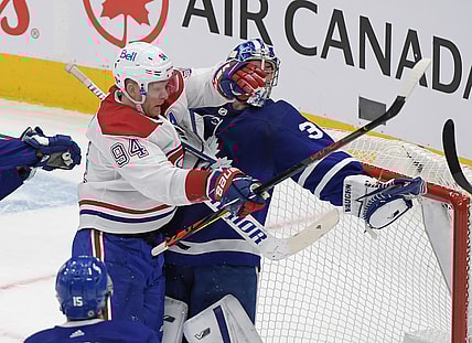 May 8, 2021; Toronto, Ontario, CAN;  Toronto Maple Leafs goalie Jack Campbell (36) holds the puck in his glove as he is bodychecked by Montreal Canadiens forward Corey Perry (94) in the first period at Scotiabank Arena. Mandatory Credit: Dan Hamilton-USA TODAY Sports