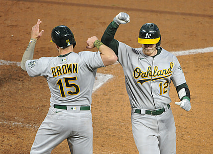May 14, 2021; Minneapolis, Minnesota, USA; Oakland Athletics Sean Murphy catcher (12) celebrates his home run with Seth Brown left fielder (15) during the fourth inning against the Minnesota Twins at Target Field. Mandatory Credit: Marilyn Indahl-USA TODAY Sports