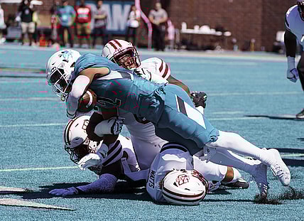 Sep 25, 2021; Conway, South Carolina, USA; Coastal Carolina Chanticleers running back Reese White (2) is tackled by the Massachusetts Minutemen in the NCAA football game of Massachusetts and Coastal Carolina at Brooks Stadium. Mandatory Credit: David Yeazell-USA TODAY Sports