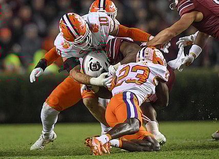 Clemson linebacker Baylon Spector (10) and  cornerback Andrew Booth Jr. (23) sack South Carolina quarterback Jason Brown (15) during the second quarter at Williams Brice Stadium in Columbia, South Carolina Saturday, November 27, 2021.

Clemson U Of Sc Football In Columbia