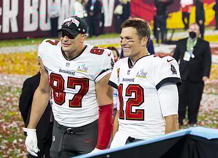 Feb 7, 2021; Tampa, FL, USA;  Tampa Bay Buccaneers quarterback Tom Brady (12) and tight end Rob Gronkowski (87) celebrate after beating the Kansas City Chiefs in Super Bowl LV at Raymond James Stadium.  Mandatory Credit: Mark J. Rebilas-USA TODAY Sports