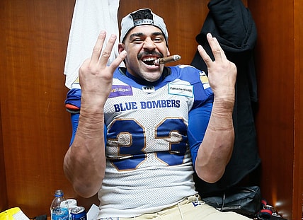 Dec 12, 2021; Hamilton, Ontario, CAN; Winnipeg Blue Bombers running back Andrew Harris (33) celebrates winning his third Grey Cup after a win over the Hamilton Tiger-Cats in the 108th Grey Cup football game at Tim Hortons Field. Mandatory Credit: John E. Sokolowski-USA TODAY Sports