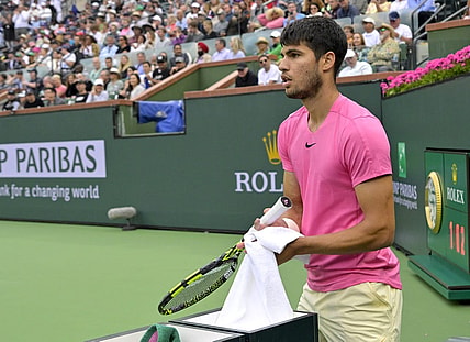 Mar 19, 2023; Indian Wells, CA, USA;  Carlos Alcaraz (ESP) wipes off his racket during the match as he defeated Daniil Medvedev (RUS) in the men   s final of the BNP Paribas Open at the Indian Wells Tennis Garden. Mandatory Credit: Jayne Kamin-Oncea-USA TODAY Sports