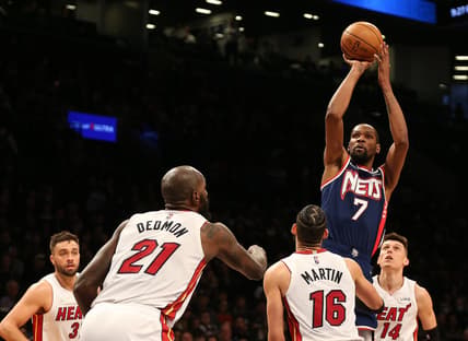 Mar 3, 2022; Brooklyn, New York, USA; Brooklyn Nets forward Kevin Durant (7) shoots as Miami Heat center Dewayne Dedmon (21) and Caleb Martin (16) look on during the second half at Barclays Center. Mandatory Credit: Andy Marlin-USA TODAY Sports
