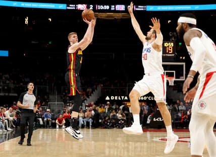 Mar 11, 2022; Atlanta, Georgia, USA; Atlanta Hawks guard Kevin Huerter (3) attempts a three point basket against LA Clippers center Ivica Zubac (40) during the first quarter at State Farm Arena. Mandatory Credit: Jason Getz-USA TODAY Sports