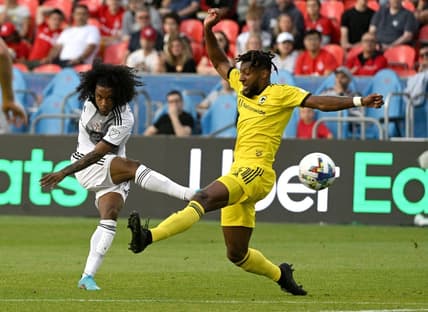 Jun 29, 2022; Toronto, Ontario, CAN; Toronto FC midfielder Jayden Nelson (11) shoots the ball past Columbus Crew defender Steven Moreira (31) in the first half at BMO Field. Mandatory Credit: Dan Hamilton-USA TODAY Sports