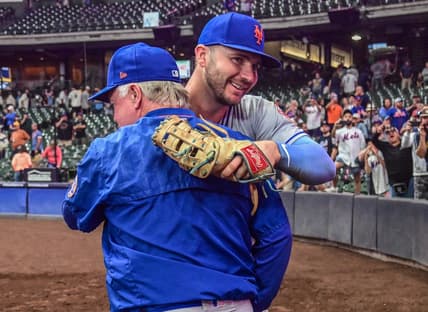 Sep 19, 2022; Milwaukee, Wisconsin, USA; New York Mets first baseman Pete Alonso (20) hugs manager Buck Showalter after the Mets clinched a playoff spot by beating the Milwaukee Brewers at American Family Field. Mandatory Credit: Benny Sieu-USA TODAY Sports