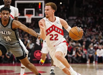 Mar 1, 2022; Toronto, Ontario, CAN; Toronto Raptors guard Malachi Flynn (22) drives to the net against Brooklyn Nets guard Cam Thomas (24) during the second half at Scotiabank Arena. Mandatory Credit: John E. Sokolowski-USA TODAY Sports