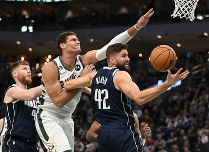 Nov 27, 2022; Milwaukee, Wisconsin, USA; Milwaukee Bucks center Brook Lopez (11) and Dallas Mavericks forward Maxi Kleber (42) battle for a rebound in the second quarter at Fiserv Forum. Mandatory Credit: Michael McLoone-USA TODAY Sports