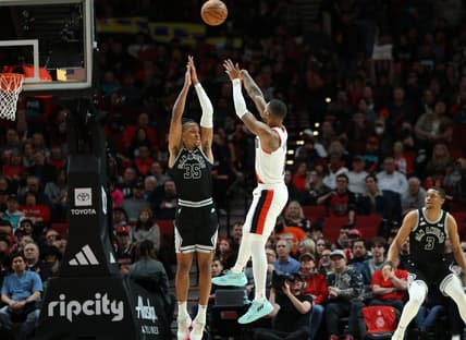 Jan 23, 2023; Portland, Oregon, USA; Portland Trail Blazers guard Damian Lillard (0) shoots the ball over San Antonio Spurs guard Romeo Langford (35) in the second half at Moda Center. Mandatory Credit: Jaime Valdez-USA TODAY Sports