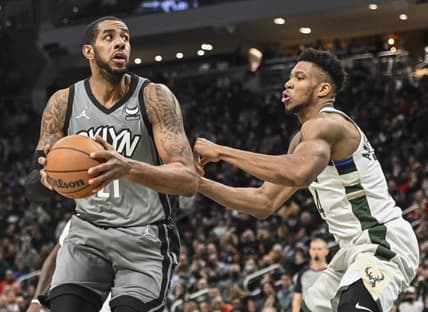Feb 26, 2022; Milwaukee, Wisconsin, USA; Brooklyn Nets center LaMarcus Aldridge (21) controls the ball against Milwaukee Bucks forward Giannis Antetokounmpo (34) in the fourth quarter at Fiserv Forum. Mandatory Credit: Benny Sieu-USA TODAY Sports
