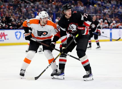 Jan 9, 2023; Buffalo, New York, USA;  Philadelphia Flyers left wing Noah Cates (49) and Buffalo Sabres center Tage Thompson (72) look for the puck during the second period at KeyBank Center. Mandatory Credit: Timothy T. Ludwig-USA TODAY Sports