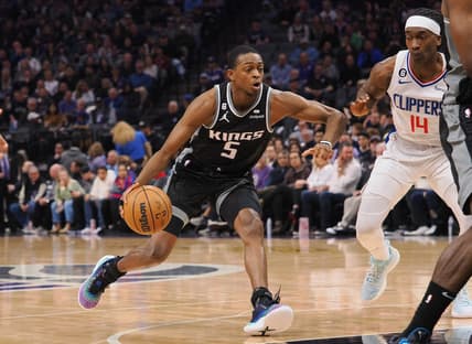 Mar 3, 2023; Sacramento, California, USA; Sacramento Kings point guard De'Aaron Fox (5) drives in against Los Angeles Clippers shooting guard Terance Mann (14) during the second quarter at Golden 1 Center. Mandatory Credit: Kelley L Cox-USA TODAY Sports