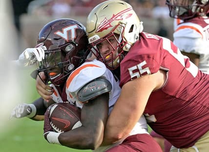 Oct 7, 2023; Tallahassee, Florida, USA; Virginia Tech Hokies running back Malachi Thomas (24) is tackled by Florida State Seminoles defensive lineman Braden Fiske (55) during the second half at Doak S. Campbell Stadium. Mandatory Credit: Melina Myers-USA TODAY Sports