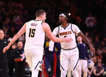 Dec 1, 2023; Phoenix, Arizona, USA; Denver Nuggets center Nikola Jokic (15) celebrates with guard Kentavious Caldwell-Pope (5) against the Phoenix Suns in the second half at Footprint Center. Mandatory Credit: Mark J. Rebilas-USA TODAY Sports
