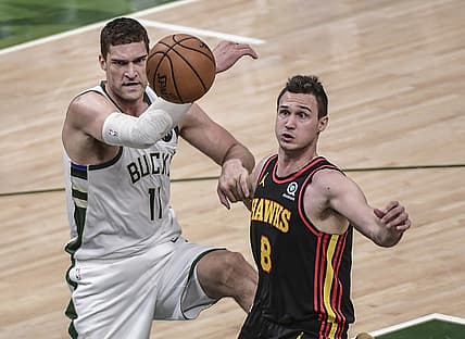 Jul 1, 2021; Milwaukee, Wisconsin, USA; Milwaukee Bucks center Brook Lopez (11) and Atlanta Hawks forward Danilo Gallinari (8) battle for a rebound in the second quarter during game five of the Eastern Conference Finals for the 2021 NBA Playoffs at Fiserv Forum. Mandatory Credit: Benny Sieu-USA TODAY Sports