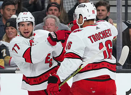 Nov 16, 2021; Las Vegas, Nevada, USA; Carolina Hurricanes defenseman Tony DeAngelo (77) celebrates with Carolina Hurricanes center Vincent Trocheck (16) after scoring a first period goal against the Vegas Golden Knights at T-Mobile Arena. Mandatory Credit: Stephen R. Sylvanie-USA TODAY Sports