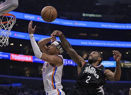 Mar 23, 2023; Los Angeles, California, USA; Los Angeles Clippers forward Kawhi Leonard (2) knocks the ball from Oklahoma City Thunder forward Ousmane Dieng (13) as he goes up for a shot in the second half at Crypto.com Arena. Mandatory Credit: Jayne Kamin-Oncea-USA TODAY Sports