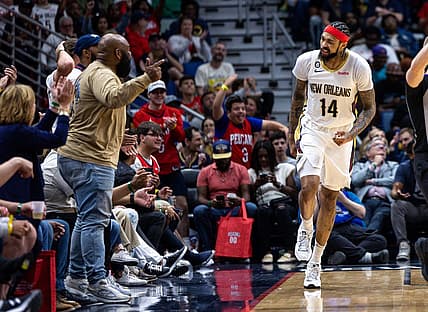 Apr 1, 2023; New Orleans, Louisiana, USA;  New Orleans Pelicans forward Brandon Ingram (14) reacts to making a basket against LA Clippers forward Kawhi Leonard (2) with a fan during the second half at Smoothie King Center. Mandatory Credit: Stephen Lew-USA TODAY Sports