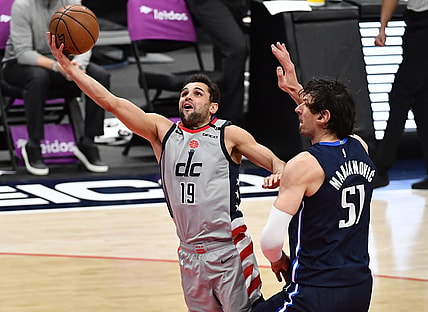 Apr 3, 2021; Washington, District of Columbia, USA; Washington Wizards guard Raul Neto (19) shoots past Dallas Mavericks center Boban Marjanovic (51) during the second quarter at Capital One Arena. Mandatory Credit: Brad Mills-USA TODAY Sports