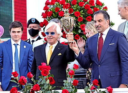 May 1, 2021; Louisville, Kentucky, USA; Medina Spirit owner Amr F. Zedan (right) and trainer Bob Baffert hold the trophy after winning the 147th running of the Kentucky Derby at Churchill Downs. Mandatory Credit: Jim Owens-USA TODAY Sports
