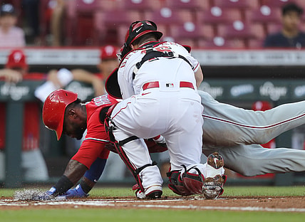 Jun 28, 2021; Cincinnati, Ohio, USA; Philadelphia Phillies center fielder Odubel Herrera (37) is tagged out at home by Cincinnati Reds catcher Tucker Barnhart (16) during the first inning at Great American Ball Park. Mandatory Credit: David Kohl-USA TODAY Sports