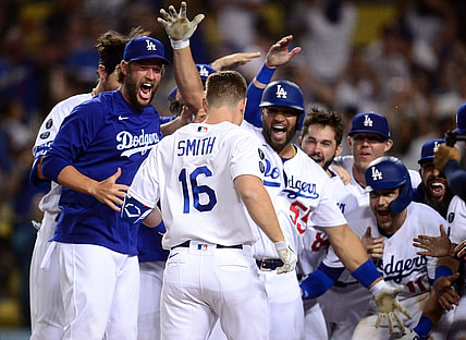 Jul 20, 2021; Los Angeles, California, USA; Los Angeles Dodgers catcher Will Smith (16) is greeted at home by pitcher Clayton Kershaw (22) and first baseman Albert Pujols (55) after hitting a walk off three run home run against the San Francisco Giants during the ninth inning at Dodger Stadium. Mandatory Credit: Gary A. Vasquez-USA TODAY Sports