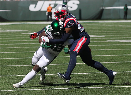 Michael Carter of the Jets is tackled by J.C. Jackson of the Patriots in the first half as the New England Patriots played the NY Jets at MetLife Stadium in East Rutherford, NJ on September 19, 2021.

The New England Patriots Came To Play The Ny Jets At Metlife Stadium In East Rutherford Nj On September 19 2021