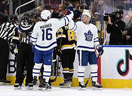Nov 6, 2021; Toronto, Ontario, CAN;  Toronto Maple Leafs forward Mitch Marner (16) is congratulated for scoring a goal by forward Alexander Kerfoot (15) in the first period against Boston Bruins at Scotiabank Arena. Mandatory Credit: Dan Hamilton-USA TODAY Sports