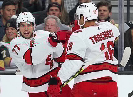 Nov 16, 2021; Las Vegas, Nevada, USA; Carolina Hurricanes defenseman Tony DeAngelo (77) celebrates with Carolina Hurricanes center Vincent Trocheck (16) after scoring a first period goal against the Vegas Golden Knights at T-Mobile Arena. Mandatory Credit: Stephen R. Sylvanie-USA TODAY Sports