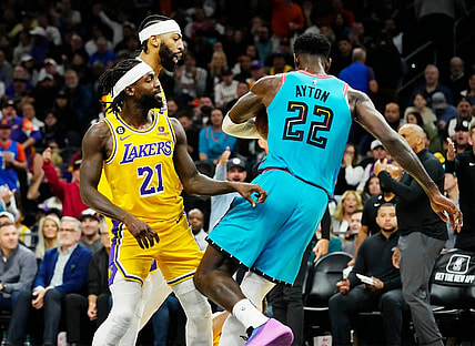 Nov 22, 2022; Phoenix, AZ, USA; Los Angeles Lakers guard Patrick Beverley (21) pushes Phoenix Suns center Deandre Ayton (22) to the court in the second half at Footprint Center. Beverley was ejected from the game. Mandatory Credit: Rob Schumacher-Arizona Republic