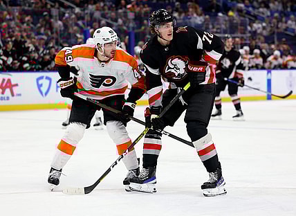 Jan 9, 2023; Buffalo, New York, USA;  Philadelphia Flyers left wing Noah Cates (49) and Buffalo Sabres center Tage Thompson (72) look for the puck during the second period at KeyBank Center. Mandatory Credit: Timothy T. Ludwig-USA TODAY Sports