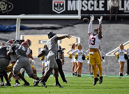 Sep 30, 2023; Boulder, Colorado, USA; Colorado Buffaloes quarterback Shedeur Sanders (2) gets his pass knocked down by USC Trojans linebacker Mason Cobb (13) during the first quarter at Folsom Field. Mandatory Credit: John Leyba-USA TODAY Sports