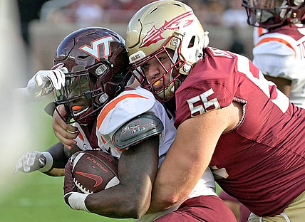 Oct 7, 2023; Tallahassee, Florida, USA; Virginia Tech Hokies running back Malachi Thomas (24) is tackled by Florida State Seminoles defensive lineman Braden Fiske (55) during the second half at Doak S. Campbell Stadium. Mandatory Credit: Melina Myers-USA TODAY Sports