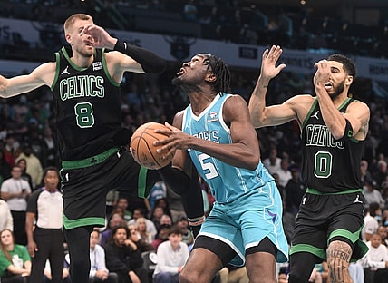 Nov 20, 2023; Charlotte, North Carolina, USA; Charlotte Hornets Center Mark Williams (5) looks to shoot as he is defended by Boston Celtics forward center Kristaps Porzingis (8) and forward Jayson Tatum (0) during the second half at the Spectrum Center. Mandatory Credit: Sam Sharpe-USA TODAY Sports