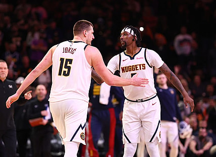 Dec 1, 2023; Phoenix, Arizona, USA; Denver Nuggets center Nikola Jokic (15) celebrates with guard Kentavious Caldwell-Pope (5) against the Phoenix Suns in the second half at Footprint Center. Mandatory Credit: Mark J. Rebilas-USA TODAY Sports