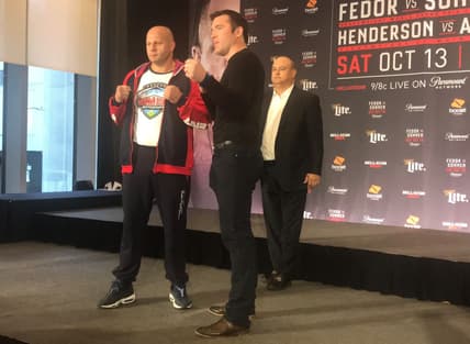 Fedor Emelianenko and Chael Sonnen pose for photographs at a media event Thursday, Oct. 11, 2018, to promote their Bellator 208 main event Saturday, Oct. 13, 2018, at Long Island's Nassau Coliseum. Bellator President Scott Coker looks on in the background.

Fedor Emelianenko vs Chael Sonnen