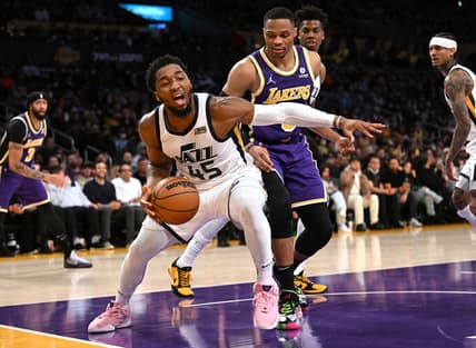 Feb 16, 2022; Los Angeles, California, USA; Utah Jazz guard Donovan Mitchell (45) and Los Angeles Lakers guard Russell Westbrook (0) reach for a loose ball in the first half at Crypto.com Arena. Mandatory Credit: Jayne Kamin-Oncea-USA TODAY Sports