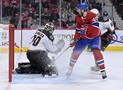Mar 15, 2022; Montreal, Quebec, CAN; Arizona Coyotes goalie Karel Vejmelka (70) makes a save against Montreal Canadiens forward Joel Armia (40) during the second period at the Bell Centre. Mandatory Credit: Eric Bolte-USA TODAY Sports