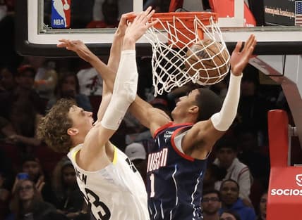 Jan 5, 2023; Houston, Texas, USA; Utah Jazz forward Lauri Markkanen (23) dunks against Houston Rockets forward Jabari Smith Jr. (1) in the second half at Toyota Center. Mandatory Credit: Thomas Shea-USA TODAY Sports