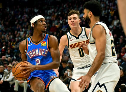 Jan 22, 2023; Denver, Colorado, USA;  Oklahoma City Thunder guard Shai Gilgeous-Alexander (2) drives to the basket as Denver Nuggets guard Jamal Murray (27) comes in on defense during the first quarter at Ball Arena. Mandatory Credit: John Leyba-USA TODAY Sports