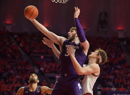 Feb 23, 2023; Champaign, Illinois, USA;  Northwestern Wildcats center Matthew Nicholson (34) grabs a rebound in front of Illinois Fighting Illini forward Matthew Mayer (24) during the first half at State Farm Center. Mandatory Credit: Ron Johnson-USA TODAY Sports