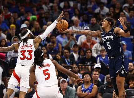 Nov 21, 2023; Orlando, Florida, USA; Toronto Raptors guard Gary Trent Jr. (33) and Orlando Magic forward Paolo Banchero (5) go after the basket during the second half at Amway Center. Mandatory Credit: Kim Klement Neitzel-USA TODAY Sports