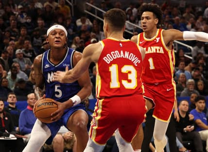 Jan 7, 2024; Orlando, Florida, USA; Orlando Magic forward Paolo Banchero (5) drives to the basket as Atlanta Hawks guard Bogdan Bogdanovic (13) defends during the second half at Kia Center. Mandatory Credit: Kim Klement Neitzel-USA TODAY Sports