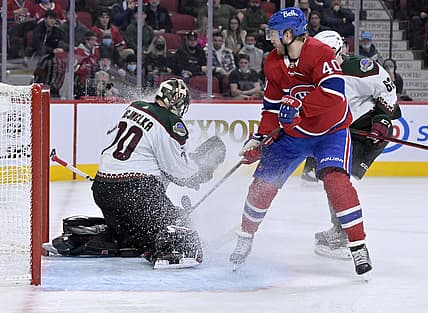 Mar 15, 2022; Montreal, Quebec, CAN; Arizona Coyotes goalie Karel Vejmelka (70) makes a save against Montreal Canadiens forward Joel Armia (40) during the second period at the Bell Centre. Mandatory Credit: Eric Bolte-USA TODAY Sports
