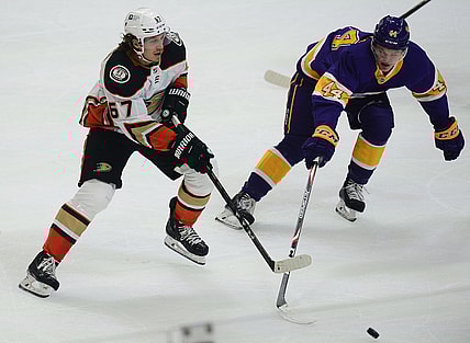Feb 2, 2021; Los Angeles, California, USA; Anaheim Ducks center Rickard Rakell (67) passes the puck against Los Angeles Kings defenseman Mikey Anderson (44) during the first period at Staples Center. Mandatory Credit: Gary A. Vasquez-USA TODAY Sports