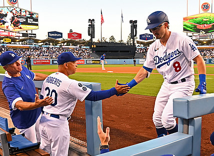 Jun 25, 2021; Los Angeles, California, USA;  Los Angeles Dodgers second baseman Zach McKinstry (8) is congratulated in the dugout by bench coach Bob Geren (88) and manager Dave Roberts (30) after hitting a solo home run in the third inning of the game against the Chicago Cubs at Dodger Stadium. Mandatory Credit: Jayne Kamin-Oncea-USA TODAY Sports
